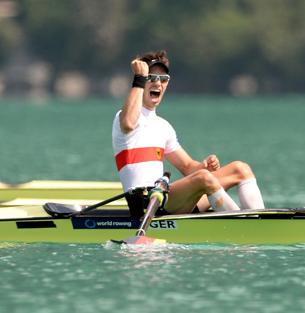 Jonas Kilthau celebrating in the single scull after crossing the finish line